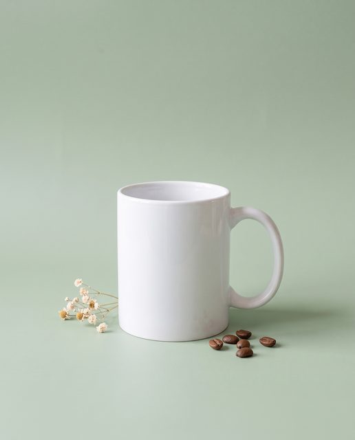 The same mug in a styled shot on a sage-green backdrop